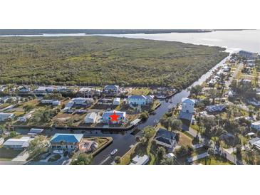 Waterfront home with a dock and boat lift offering access to the open water and natural surroundings at 4297 Nettle Rd, Port Charlotte, FL 33953