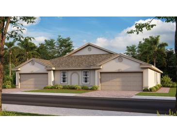 Two-car garage, tan exterior, and attractive landscaping at 9374 Sunbeam Cir, Punta Gorda, FL 33950