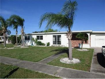 Ranch-style home with palm trees and a well-maintained lawn at 120 Rodgers Ne Ave, Port Charlotte, FL 33952