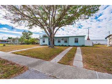 Light blue house with carport and mature tree in front yard at 3461 Normandy Dr, Port Charlotte, FL 33952