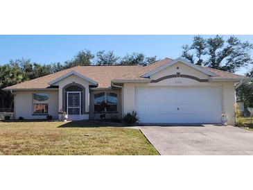 One-story home with attached garage, landscaped lawn, and neutral color scheme at 4330 Shappell St, Port Charlotte, FL 33948