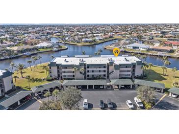 Aerial view of condo building near waterfront with parking and landscaping at 601 Shreve St # 35C, Punta Gorda, FL 33950