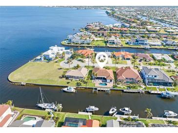 Aerial view of waterfront home with private dock and pool; located on a canal at 11 Sabal Dr, Punta Gorda, FL 33950