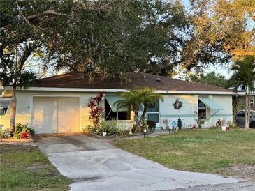 Cute ranch home with mature landscaping and a long driveway at 1148 Barbour Ave, Port Charlotte, FL 33948