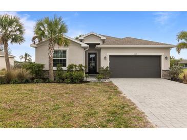 One-story home with two-car garage, paver driveway, and landscaping at 25339 Alicante Dr, Punta Gorda, FL 33955