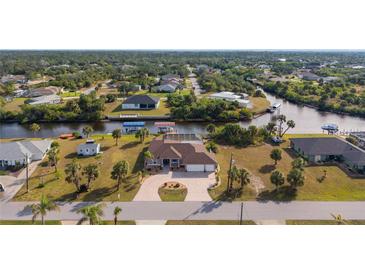 Aerial view of waterfront home with large lot and boat dock at 4122 Library St, Port Charlotte, FL 33948