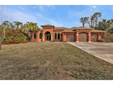 Attractive single-story home with three-car garage and lush landscaping at 3000 Narcissus Ter, North Port, FL 34286