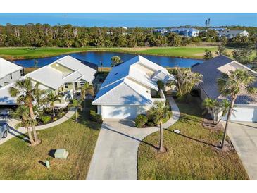 Aerial view of a charming villa community with golf course views at 10 Windward Ct, Placida, FL 33946