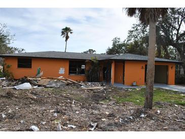 Orange single story house undergoing renovation, lot is cleared at 201 Winson Ave, Englewood, FL 34223