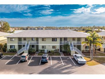 Aerial view of a condo building with parking and water access at 25225 Rampart Blvd # 1701, Punta Gorda, FL 33983