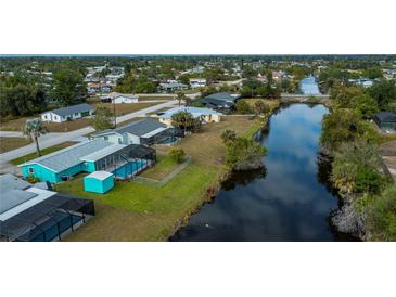 Aerial view of canal-front home with pool and lush landscaping at 3448 Middletown St, Port Charlotte, FL 33952