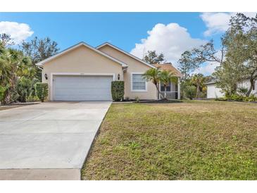 Single-story house with a two-car garage and a well-manicured lawn at 5547 Wagon Wheel Dr, North Port, FL 34291