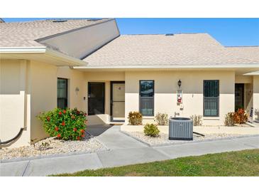 Exterior view of condo, featuring a walkway and landscaping at 1415 San Cristobal Ave # A4, Punta Gorda, FL 33983