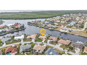 Aerial view of waterfront home with canal access, showcasing a desirable location at 1435 Sea Fan Dr, Punta Gorda, FL 33950