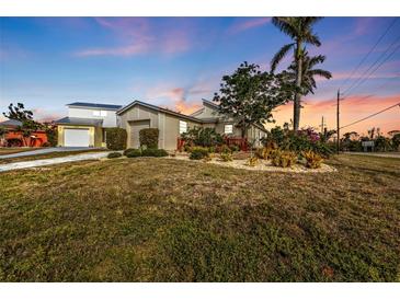 Charming house with a well-manicured lawn and mature trees at 3114 Magdalina Dr, Punta Gorda, FL 33950
