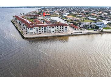 Aerial view of waterfront condo building with parking and water access at 1 Colony Point Dr # A19, Punta Gorda, FL 33950