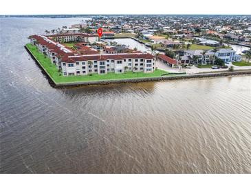 Aerial view of waterfront condos with lush lawns and stunning water views at 1 Colony Point Dr # A19, Punta Gorda, FL 33950