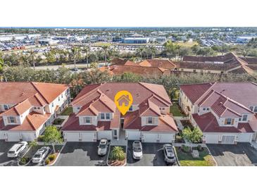 Aerial view of a community of townhouses with red tile roofs and attached garages at 240 W End Dr # 412, Punta Gorda, FL 33950