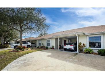 Charming single-story home features a covered carport, well-maintained landscaping, and a welcoming entrance at 27251 Adams St # 212, Punta Gorda, FL 33983