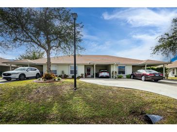 Two-unit condo building with carport parking and nicely landscaped grounds at 27251 Adams St # 212, Punta Gorda, FL 33983