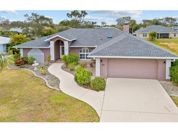 Single-story home with gray roof, attached garage, and landscaped yard at 287 Fortaleza St, Punta Gorda, FL 33983