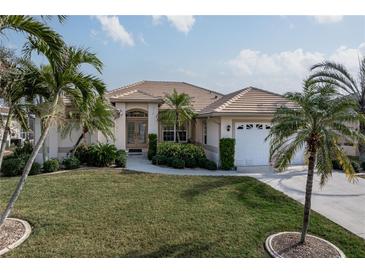 Single-story home with tile roof, landscaping, and two-car garage at 5430 Almar Dr, Punta Gorda, FL 33950