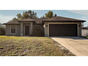 Newly constructed home with a two-car garage and well-manicured lawn at 1101 Victoria Ave, Port Charlotte, FL 33948