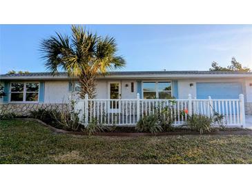 Charming single story home with white picket fence and landscaped yard at 145 Dartmouth Nw Dr, Port Charlotte, FL 33952