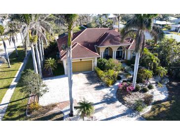 Aerial view of single-story home with tile roof, landscaping, and driveway at 220 Shreve St, Punta Gorda, FL 33950