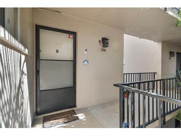 Inviting front door entrance of unit 206 features a welcome mat at 2763 Woodgate Ln # 206, Sarasota, FL 34231