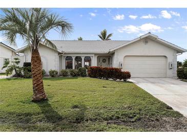 Single-story home with attached garage and manicured lawn at 3749 Bordeaux Dr, Punta Gorda, FL 33950