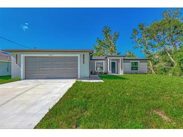 Newly constructed home with attached garage and spacious lawn at 1325 Goshen Rd, North Port, FL 34288
