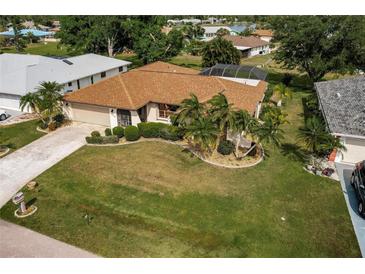 Single-story home with a large yard and mature landscaping at 2408 Montpelier Rd, Punta Gorda, FL 33983