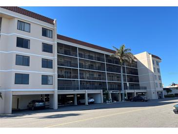 Condominium exterior with covered parking and screened in balconies, conveniently located near the beach at 25188 Marion Ave # F201, Punta Gorda, FL 33950