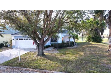 Charming single-story home with a well-manicured lawn and mature trees at 26166 Stillwater Cir, Punta Gorda, FL 33955