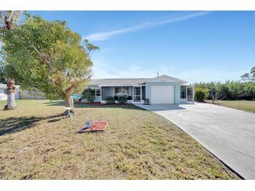 Single-story home with a carport and a well-maintained lawn at 27131 Ann Arbor Ave, Punta Gorda, FL 33983
