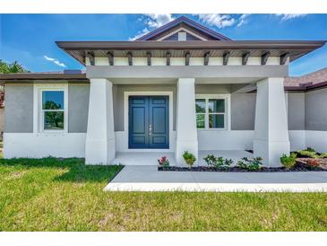 House exterior features a dark-grey front door and light-grey siding at 3501 New London St, North Port, FL 34288