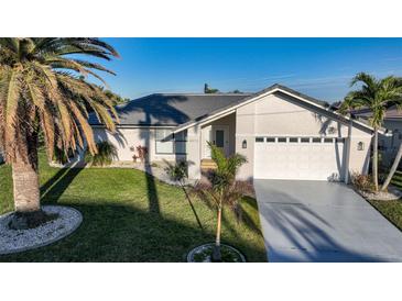 Single-story home with attached garage and landscaped lawn at 4072 San Massimo Dr, Punta Gorda, FL 33950