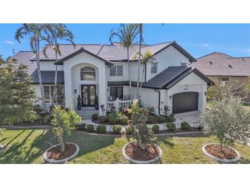 Stunning two-story home with a beautiful front yard and landscaping at 1217 Spoonbill Dr, Punta Gorda, FL 33950