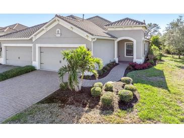 Well-maintained house with two-car garage, paved driveway and landscaped front yard at 1259 Backspin Dr, Englewood, FL 34223