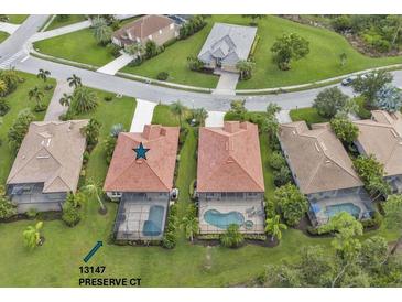 House in a residential community with swimming pools and green spaces at 13147 Preserve Ct, Port Charlotte, FL 33953