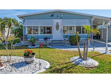 Charming single-story home with a well-maintained lawn, pretty landscaping, and a welcoming front entrance at 136 Seaward Way, North Port, FL 34287