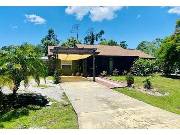 Single-story house with a covered patio and landscaped lawn at 18085 Wintergarden Ave, Port Charlotte, FL 33948