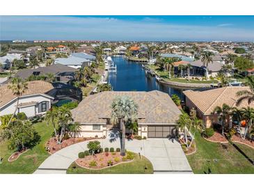 Aerial view of waterfront home with landscaped yard and community at 2748 Saint Thomas Dr, Punta Gorda, FL 33950