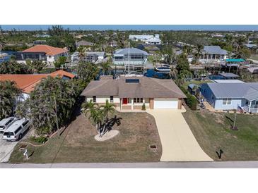 Aerial view of single-story home with canal access and private dock at 520 Boardman Dr, Punta Gorda, FL 33950