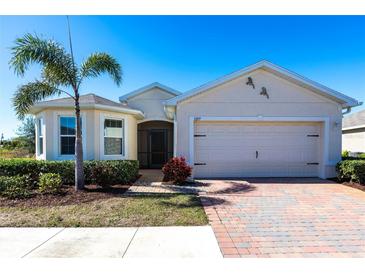 Single-story home with a two-car garage and landscaped yard at 5277 Shell Mound Cir, Punta Gorda, FL 33982