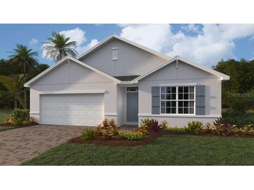 One-story home with gray siding, white garage door, and landscaping at 9525 Turtle Grass Cir, Punta Gorda, FL 33950