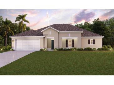 Single-story home with a two-car garage and landscaped lawn at 2090 Mauritania Rd, Punta Gorda, FL 33983