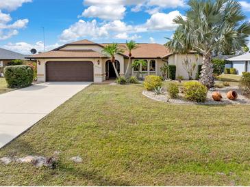 Well maintained single Gathering home with lovely landscaping and a two car garage at 2149 Rio De Janeiro Ave, Punta Gorda, FL 33983