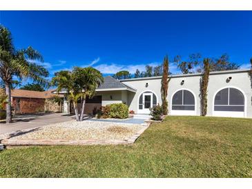 Single-story house with a landscaped yard, driveway, and attached garage at 22498 Westchester Blvd, Punta Gorda, FL 33980